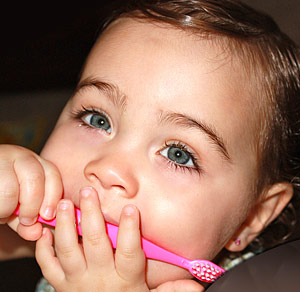 A young patient holding a toothbrush