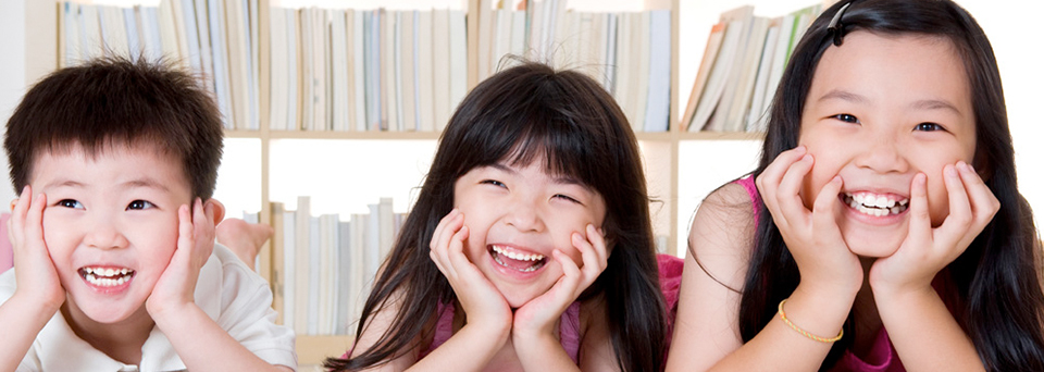 Three children smiling together