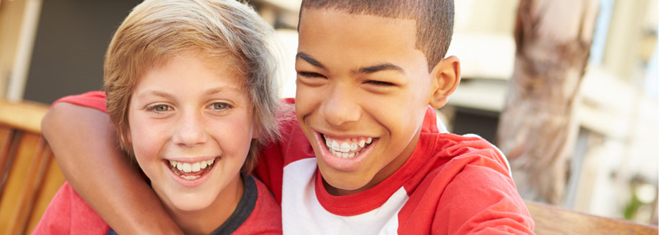 Two older children smiling
